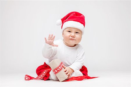 simsearch:400-09222788,k - Adorable young baby boy wearing a Santa hat opening Christmas presents Photographie de stock - Aubaine LD & Abonnement, Code: 400-08888061