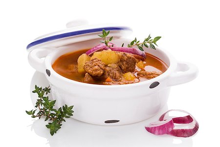 simsearch:400-07572068,k - Delicious goulash soup in white pot on white background. Culinary traditional goulash eating. Stock Photo - Budget Royalty-Free & Subscription, Code: 400-08888168