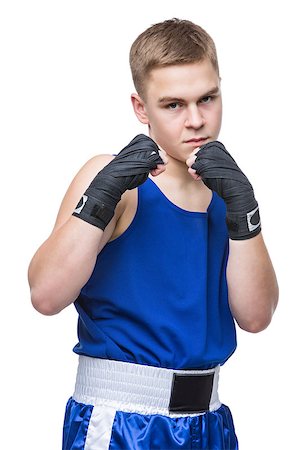 simsearch:400-04922500,k - Young handsome boxer sportsman in blue boxer suit and black wrist wraps standing on white backgound. Isolated. Copy space. Photographie de stock - Aubaine LD & Abonnement, Code: 400-08888255