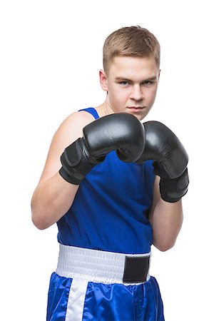 simsearch:400-04922500,k - Young handsome boxer sportsman in blue boxer suit and black gloves standing on white backgound. Isolated. Copy space. Photographie de stock - Aubaine LD & Abonnement, Code: 400-08888256