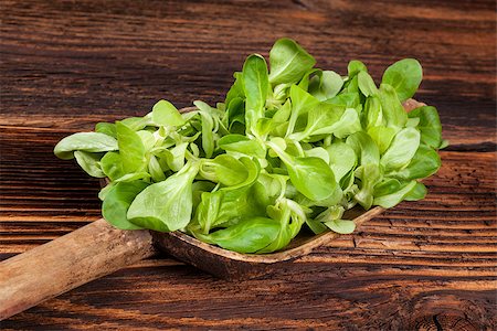 Fresh green lamb's lettuce salad on wooden spoon on old wooden vintage background. Fresh salad, rustic vintage country style image. Stock Photo - Budget Royalty-Free & Subscription, Code: 400-08888714