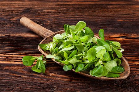 Fresh green field salad on old wooden spoon on rustic vintage wooden background. Fresh salad, rustic vintage country style image. Stock Photo - Budget Royalty-Free & Subscription, Code: 400-08888716