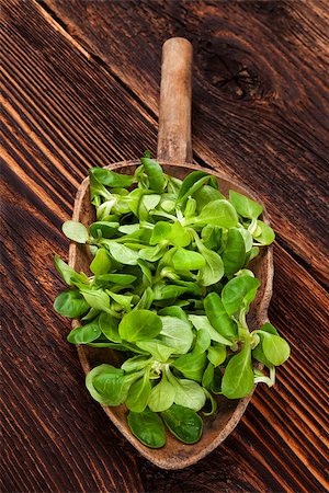 Fresh green field salad on old wooden spoon on rustic vintage wooden background. Fresh salad, rustic vintage country style image. Stock Photo - Budget Royalty-Free & Subscription, Code: 400-08888717