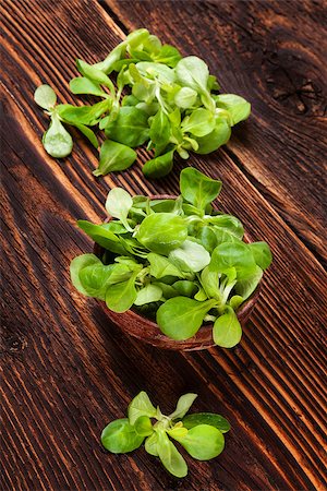 Fresh lamb's lettuce salad in wooden bowl on old wooden vintage background. Fresh salad, rustic vintage country style image. Stock Photo - Budget Royalty-Free & Subscription, Code: 400-08888712
