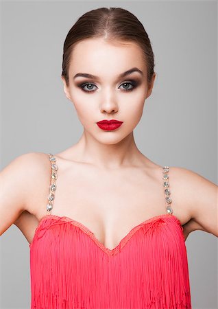 simsearch:400-04152832,k - Beautiful ballroom dancer girl portrait red dress on grey background Stock Photo - Budget Royalty-Free & Subscription, Code: 400-08889034