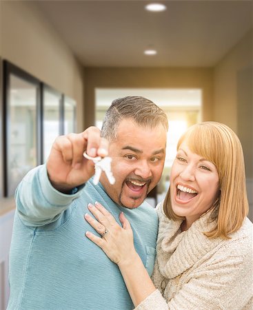 Mixed Race Couple Holding House Keys Inside Hallway of Their New Home. Stock Photo - Budget Royalty-Free & Subscription, Code: 400-08889865
