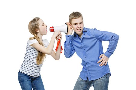 simsearch:400-08899268,k - Teen age girl screaming at boy through megaphone. Brother and sister isolated on white background. Copy space. Stockbilder - Microstock & Abonnement, Bildnummer: 400-08899269