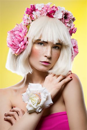simsearch:859-07845866,k - Beautiful young woman in pink dress and blond wig with floral head accessory standing over yellow background. Closeup beauty portrait. Copy space. Stock Photo - Budget Royalty-Free & Subscription, Code: 400-08899274