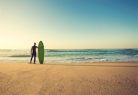 simsearch:400-05319489,k - Surfer on the beach holding is surfboaerd and watching the waves Stock Photo - Budget Royalty-Free & Subscription, Code: 400-08890616