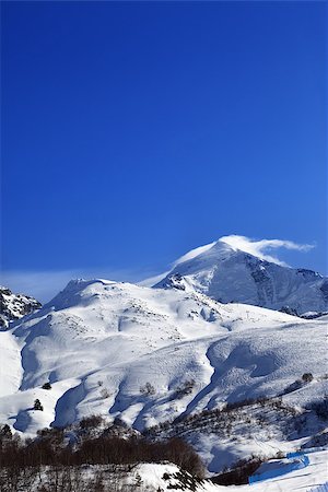 simsearch:400-08780271,k - Mount Tetnuldi and off-piste slope with track from ski and snowboard in sun day. Caucasus Mountains, Svaneti region of Georgia. Photographie de stock - Aubaine LD & Abonnement, Code: 400-08890647