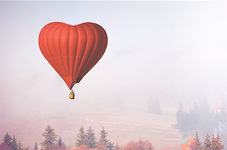 simsearch:400-09090841,k - Red air balloon in shape of heart fly above forest in foggy morning. Romantic postcard background on Valentine's Day. Adventure trip for couples. Sport and recreation travel theme. Nature background Stock Photo - Budget Royalty-Free & Subscription, Code: 400-08890821