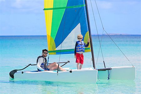 family catamaran - family of two, father and son, enjoying sailing together at hobie cat catamaran, active healthy lifestyle Stock Photo - Budget Royalty-Free & Subscription, Code: 400-08891184