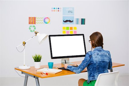 Woman working at desk In a creative office, using a computer Stock Photo - Budget Royalty-Free & Subscription, Code: 400-08891328