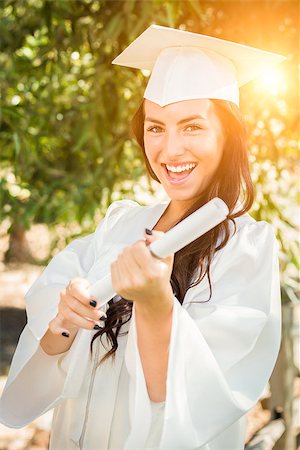Attractive Mixed Race Girl Celebrating Her Graduation Outside In Cap and Gown with Diploma in Hand. Stock Photo - Budget Royalty-Free & Subscription, Code: 400-08891458