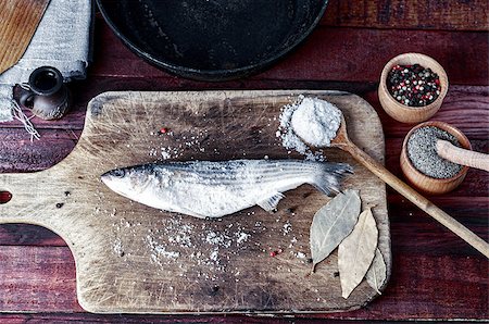 simsearch:400-06088770,k - Fresh fish smelt spices for cooking on a kitchen board, a number of spices and frying pan Stock Photo - Budget Royalty-Free & Subscription, Code: 400-08891585