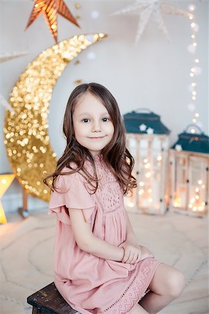 simsearch:400-08890472,k - Portrait of a smiling pretty girl posing against the sparkling decoration. Christmas, birthday, party time. Stockbilder - Microstock & Abonnement, Bildnummer: 400-08891603