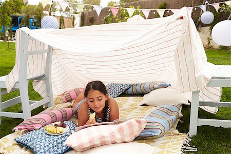 simsearch:400-08891803,k - Girl Reading Book and Eating Snack In Home Made Garden Den Stock Photo - Budget Royalty-Free & Subscription, Code: 400-08891706