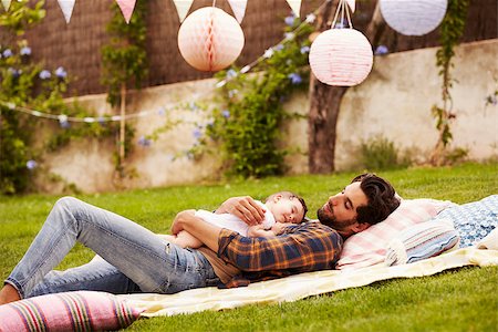 Father With Baby Relaxing On Rug In Garden Together Stock Photo - Budget Royalty-Free & Subscription, Code: 400-08891722