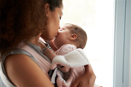 simsearch:400-08891803,k - Close Up Of Mother Cuddling Baby Daughter At Home Stock Photo - Budget Royalty-Free & Subscription, Code: 400-08891805