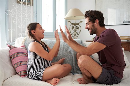 simsearch:400-08891803,k - Father And Daughter Playing Clapping Game Sitting On Sofa Stock Photo - Budget Royalty-Free & Subscription, Code: 400-08891829