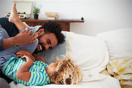 Father And Son Playing Game On Sofa Together Stock Photo - Budget Royalty-Free & Subscription, Code: 400-08891862