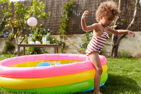 Girl Having Fun In Garden Paddling Pool Stock Photo - Budget Royalty-Free & Subscription, Code: 400-08891870