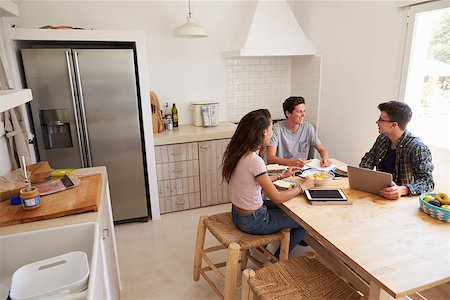 simsearch:400-08892368,k - Three teens study in kitchen using computers, elevated view Stock Photo - Budget Royalty-Free & Subscription, Code: 400-08892287