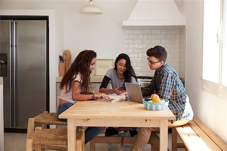 simsearch:400-08892339,k - Three teens studying in a kitchen using computers, side view Stock Photo - Budget Royalty-Free & Subscription, Code: 400-08892280