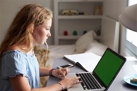 simsearch:400-08892339,k - Teenage girl using laptop at a desk in her bedroom, close up Stock Photo - Budget Royalty-Free & Subscription, Code: 400-08892318