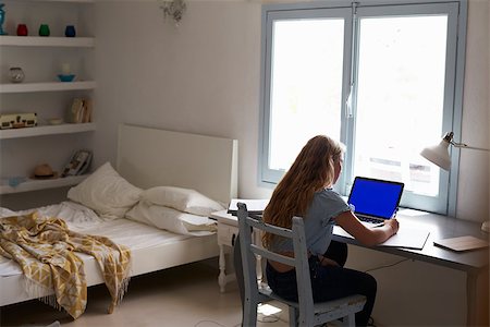 simsearch:400-08892339,k - Teenage girl working with laptop at a desk in her bedroom Stock Photo - Budget Royalty-Free & Subscription, Code: 400-08892323