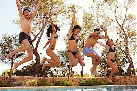 simsearch:400-08892368,k - Five teenagers jumping into an outdoor swimming pool, Ibiza Stock Photo - Budget Royalty-Free & Subscription, Code: 400-08892374