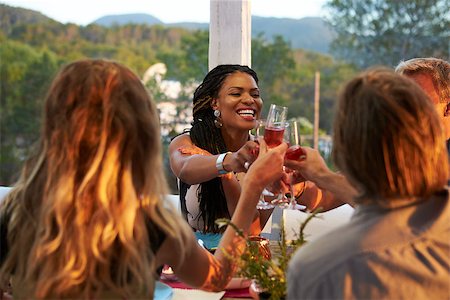 sunset meal - Couples toasting at dinner on a terrace, over shoulder view Stock Photo - Budget Royalty-Free & Subscription, Code: 400-08892448