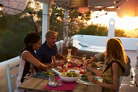 sunset meal - Two couples eating dinner at sunset on a rooftop terrace Stock Photo - Budget Royalty-Free & Subscription, Code: 400-08892443