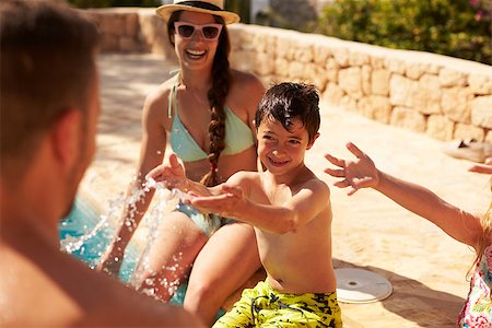 Family On Vacation Having Fun By Outdoor Pool Stock Photo - Budget Royalty-Free & Subscription, Code: 400-08892458