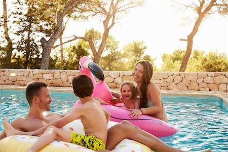 Family On Vacation On Inflatables In Outdoor Swimming Pool Stock Photo - Budget Royalty-Free & Subscription, Code: 400-08892485