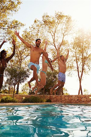 Group Of Friends On Vacation Jumping Into Outdoor Pool Stock Photo - Budget Royalty-Free & Subscription, Code: 400-08892480