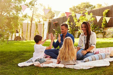 simsearch:400-08891803,k - Family Relaxing On Blanket In Garden Stock Photo - Budget Royalty-Free & Subscription, Code: 400-08892491