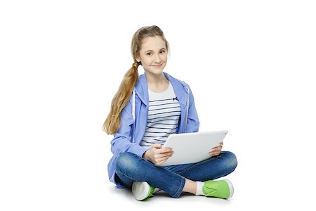 Beautiful teen age girl in casual clothes sitting on floor with big electronic tablet. Isolated on white background. Stock Photo - Budget Royalty-Free & Subscription, Code: 400-08900097