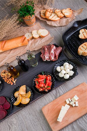 Bruschetta Ingredients for preparation with board and knife. Italian food. Stock Photo - Budget Royalty-Free & Subscription, Code: 400-08916570