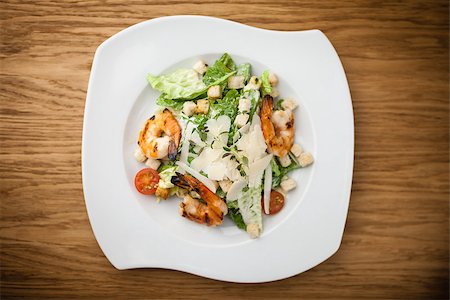 Caesar Salad with shrimps served on a plate in restaurant Stock Photo - Budget Royalty-Free & Subscription, Code: 400-08917255