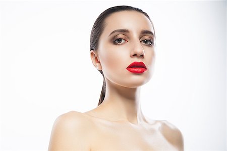 Attractive young female with red lips looking at camera. Horizontal studio shot. Fotografie stock - Microstock e Abbonamento, Codice: 400-08917721