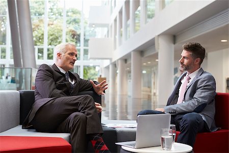 Two Businessmen Meeting In Lobby Area Of Modern Office Stock Photo - Budget Royalty-Free & Subscription, Code: 400-08937476