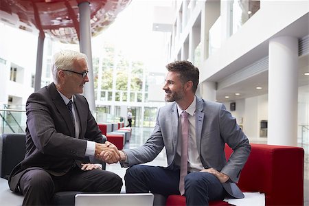 Two Businessmen Shaking Hands In Lobby Of Modern Office Stock Photo - Budget Royalty-Free & Subscription, Code: 400-08937485