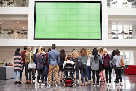 simsearch:400-08937692,k - Students looking up at a big screen in university atrium Stock Photo - Budget Royalty-Free & Subscription, Code: 400-08937718