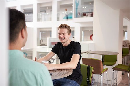 simsearch:400-08937692,k - Young adult male students talking in modern university cafe Stock Photo - Budget Royalty-Free & Subscription, Code: 400-08937739