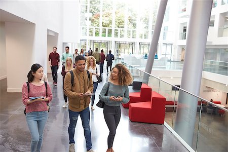 simsearch:400-08937692,k - Students walk and talk using mobile devices in university Stock Photo - Budget Royalty-Free & Subscription, Code: 400-08937744