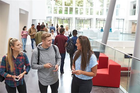 simsearch:400-08937692,k - Students holding tablets and phone talk in university lobby Stock Photo - Budget Royalty-Free & Subscription, Code: 400-08937743