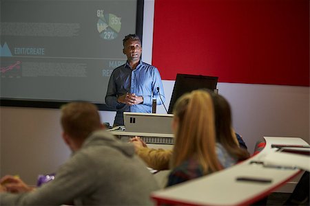 student teacher with tablet - Lecture in a darkened university lecture theatre, student POV Stock Photo - Budget Royalty-Free & Subscription, Code: 400-08937767