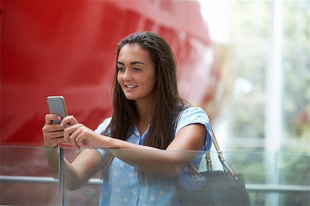 simsearch:400-08937692,k - Female student uses smartphone in modern university building Stock Photo - Budget Royalty-Free & Subscription, Code: 400-08937804