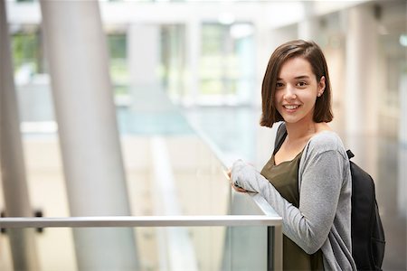 simsearch:400-08937692,k - Smiling dark haired female student in university building Stock Photo - Budget Royalty-Free & Subscription, Code: 400-08937806